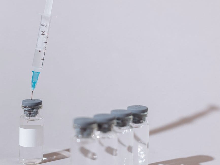 covid vaccine bottles and syringe